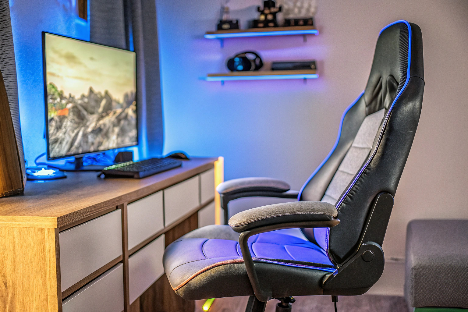 Ein Gaming-Stuhl mit integrierten LED-Leuchten und Massagefunktion, der in einem modernen Gaming-Setup verwendet wird. Gaming-Stuhl mit zusätzlichen Features